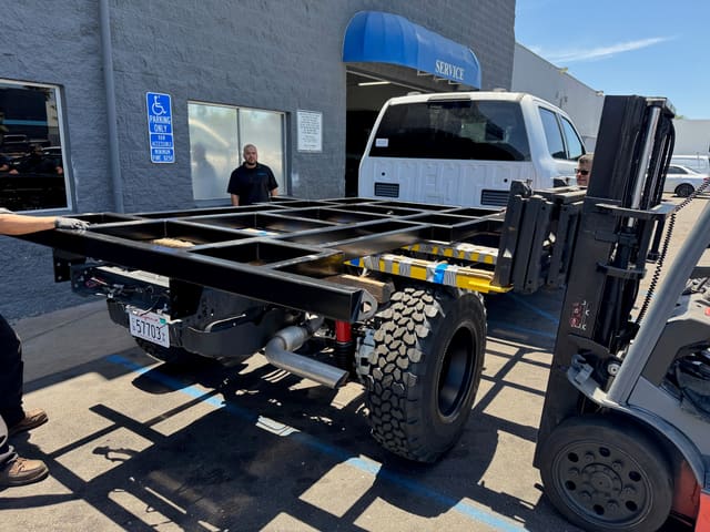 Welded sub-frame carried on a forklift toward the F-550